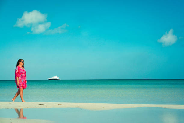 A large white yacht anchored in the sea.