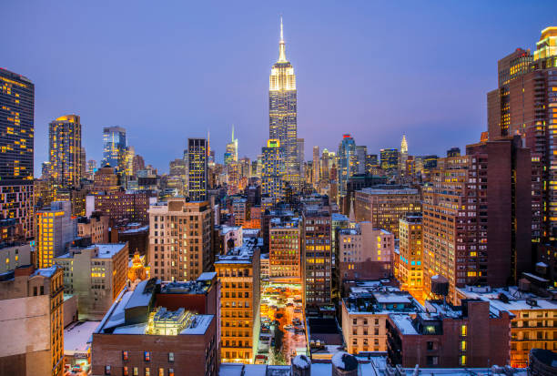 empire state building and midtown manhattan at dusk, new york city, usa - manhattan new york city night skyline imagens e fotografias de stock