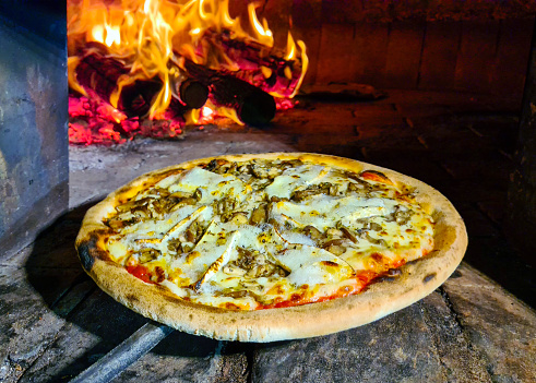Baked pizza in the wood oven, brie cheese