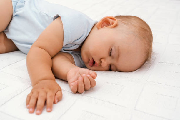istock Sleeping baby on white blanket, close-up portrait 1343868276