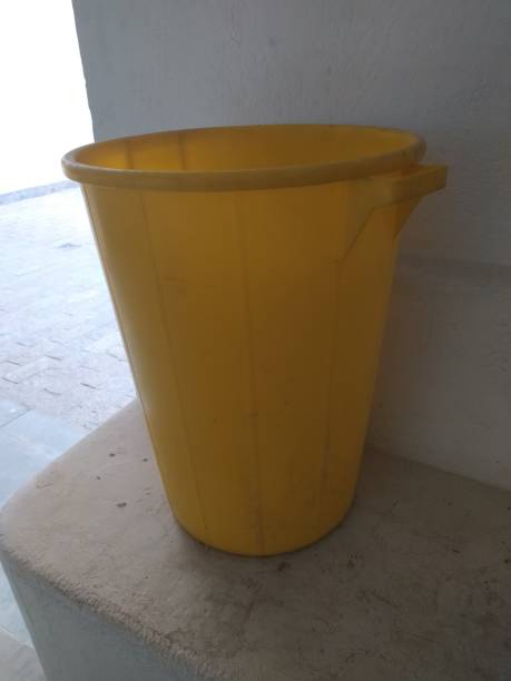 istock Large yellow basket over a white concrete surface 1343868970