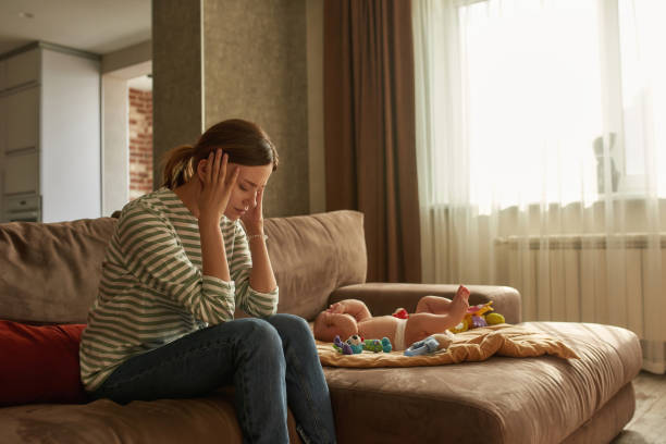 istock Young mother suffering from chronic headache caused by instant baby crying 1343870711