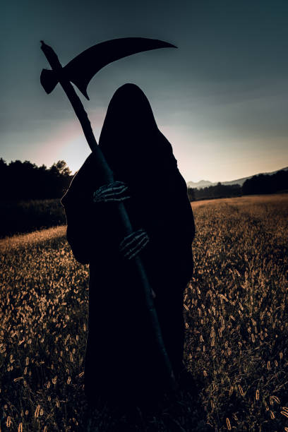 istock Silhuette of Grim Reaper in sunset. 1343871017