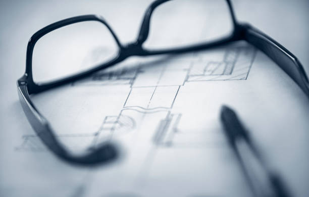 istock Glasses and pen on top of technical drawing. 1343871243