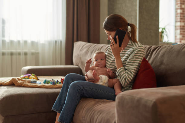 istock Desperate mother calling to clinic to set appointment 1343872314