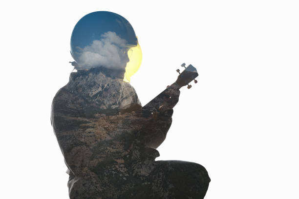 A man is playing guitar doble exposure nature landscape in background