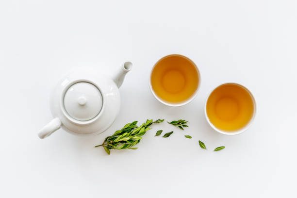 istock Tea ceremony with with white teapot and two cups, top view 1343872386