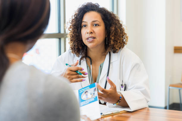 istock Unrecognizable patient holds brochure as doctor explains treatment options 1343874704