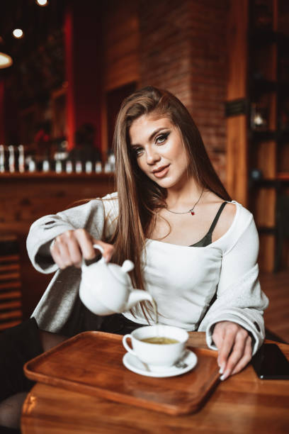 istock Tea Time For Lovely Blond Female Pouring It From Kettle Into Cup 1343874892