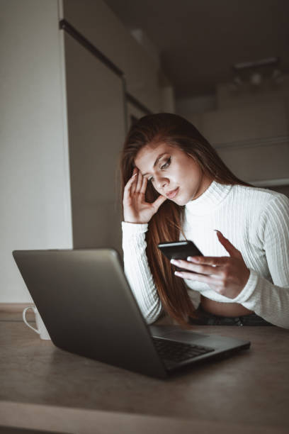 istock Stressed Female Focusing On Work From Home Using Laptop And Smartphone 1343874929
