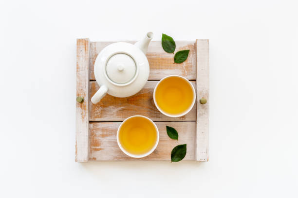 istock Tea ceremony with with white teapot and two cups, top view 1343875020