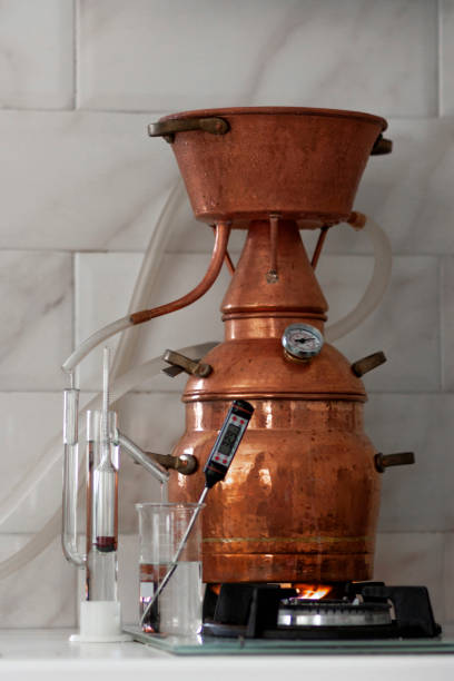 istock The process of making a strong alcoholic beverage at home. Copper alembic. 1343877620