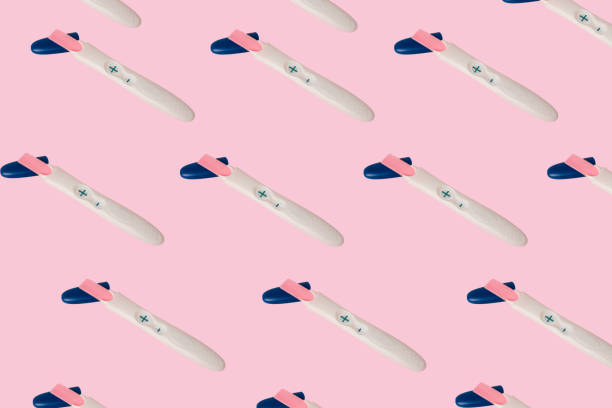 istock Pattern with a positive pregnancy test on a pink background 1343878262