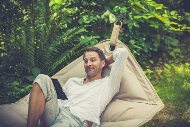istock relaxing and reading ebooks in the garden 1343881522