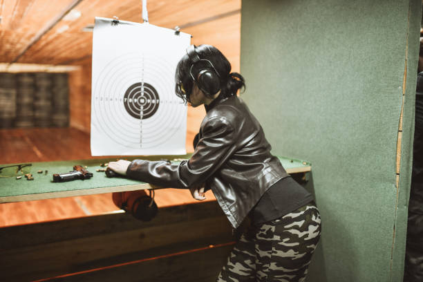 istock Female Examining Shooting Results On Gun Range 1343881549