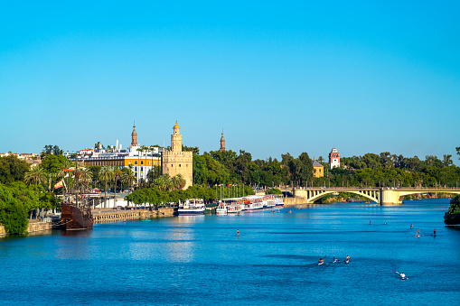 Historic military watchtower in Seville, Spain called the Torre del Oro on the banks of the Guadalquivir river.