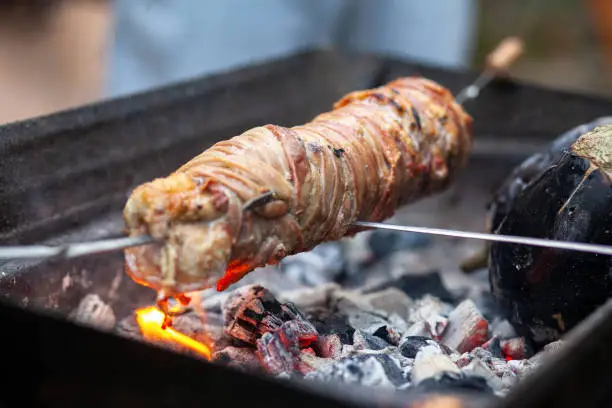 View of a rolled kokorec on grill.

Kokorec is a dish of the Balkans and Asia Minor, consisting of lamb or goat intestines wrapped around seasoned offal, including sweetbreads, hearts, lungs, or kidneys, and typically grilled; a variant consists of chopped innards cooked on a griddle. The intestines of suckling lambs are preferred.