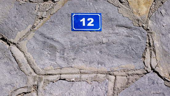 Door number on stone wall