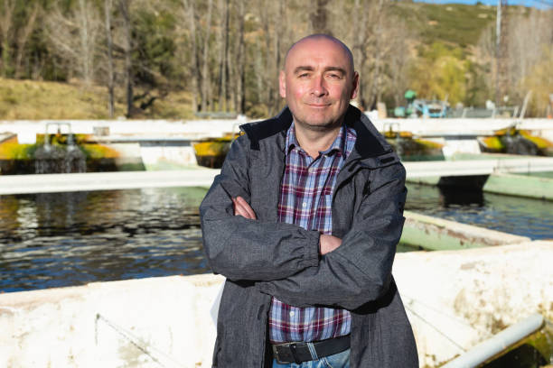 Man owner of trout fish farm Outdoors portrait of confident man owner of trout fish farm hatchery stock pictures, royalty-free photos & images