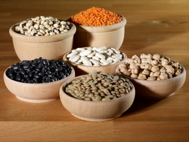 Various pulses in wooden bowl stock photo
