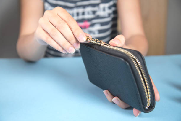 istock the young woman opening wallet 1343887406