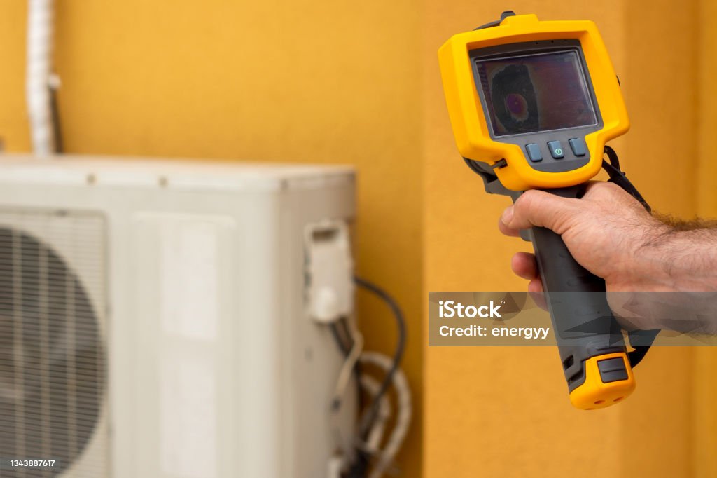 Infrared Thermal Imaging Camera Pointing to Air Conditioning Air Conditioner Stock Photo