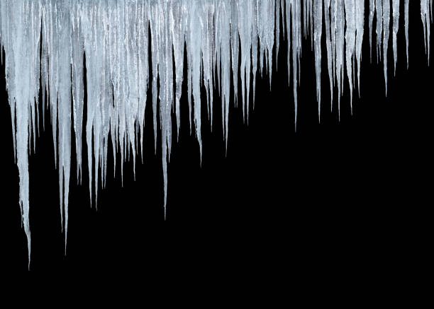 istock group of long icicles isolated on black 1343888994