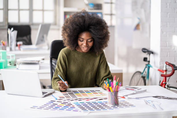 istock Young afro woman in a creative office working with color samples 1343889373