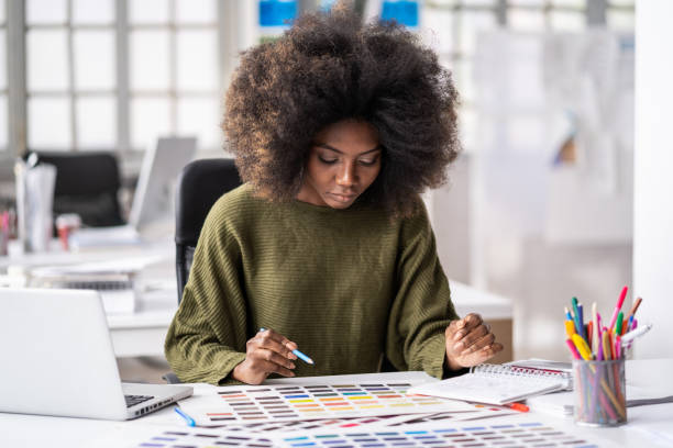 istock Young afro woman in a creative office working with color samples 1343889378