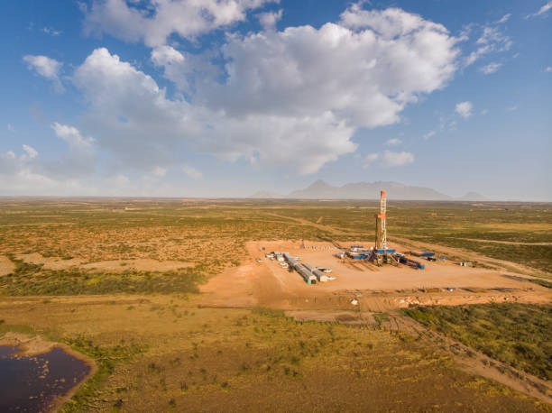 istock Fracking Drilling Rig Evening Shot under dramatic Sky in West Texas with Settling Ponds on the Prairie 1343889430