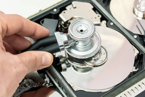istock hard drive diagnostics with a stethoscope. Recovery, search lost data, information in hdd repair service 1343889486