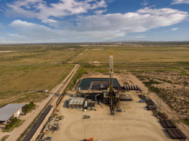 istock Fracking Drilling Rig Evening Shot under dramatic Sky in West Texas with Settling Ponds on the Prairie 1343890069