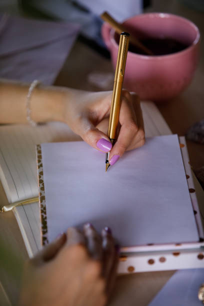 istock Unrecognizable woman writing an address on an envelope 1343890994