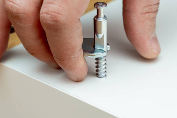 istock furniture assembling process, screwing, tightening the bolt with a special wrench instrument 1343891762