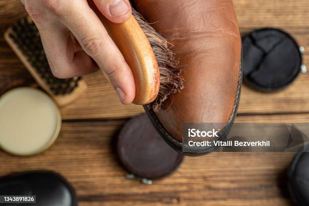 Cleaning Polishing Restoration Brown Leather Boots With Brush And Footwear Care Product Shoe Polish Stock Photo - Download Image Now