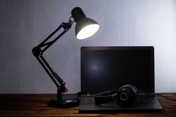 istock Laptop, headphones, table lamp, notebook, phone and flower at workplace. 1343892376