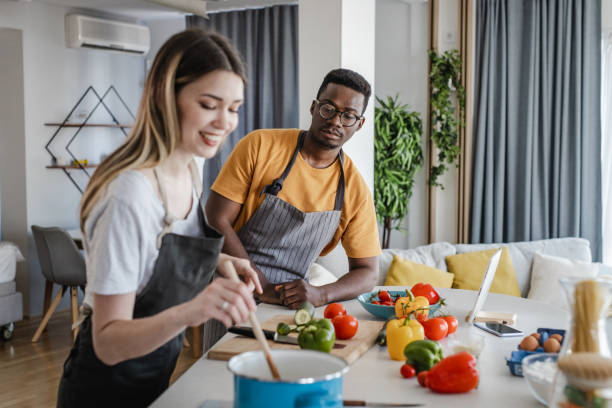 istock Couple in the kitchen, preparing a healthy meal 1343892424