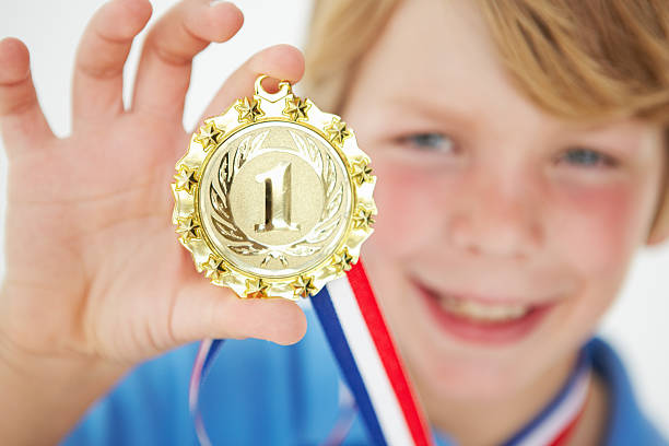 istock Young boy showing off medal 134389395