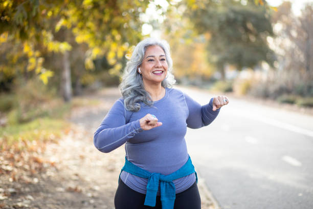 mexican woman stretching back - twisted tree california usa imagens e fotografias de stock