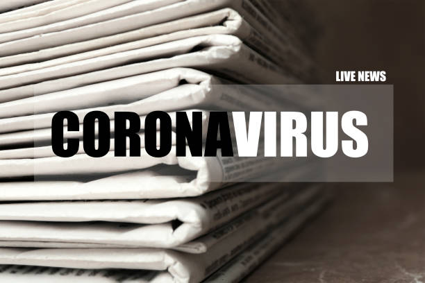 istock Word CORONAVIRUS and stack of newspapers on table, closeup. Journalist's work 1343896772