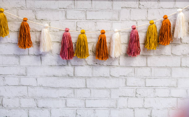 Tassels on a string Pretty, colored, tassels hanging on a string - used for decor. macrame photos stock pictures, royalty-free photos & images