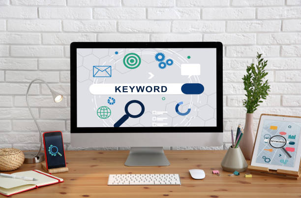 istock Keywords research concept. Modern computer with search bar on wooden table 1343898041
