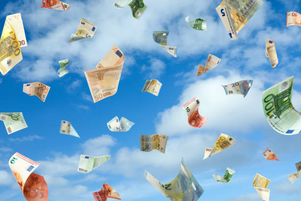 istock Falling Euro banknotes and blue sky on background. Money rain 1343899230