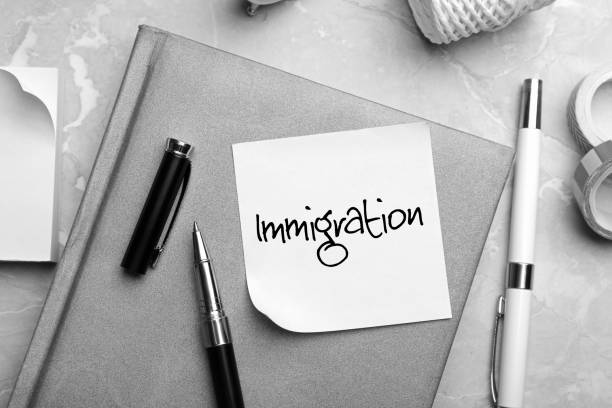 istock Note with word IMMIGRATION and stationery on grey table, flat lay 1343900112