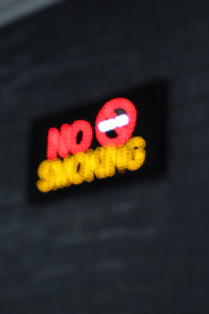istock Selective focus of Luminous LED light sign indicating smoking ban. no smoking 1343901913