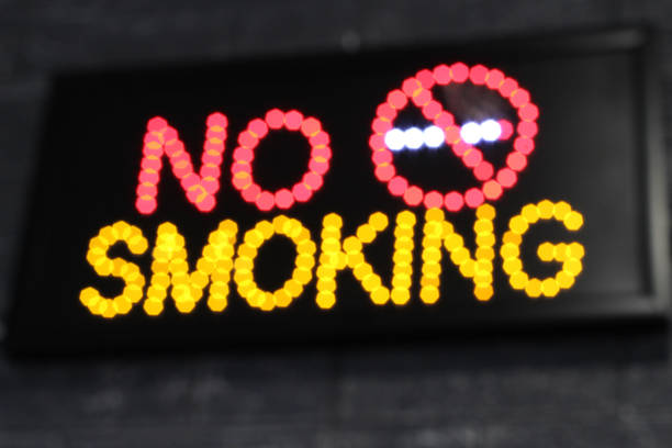 istock Selective focus of Luminous LED light sign indicating smoking ban. no smoking 1343902571