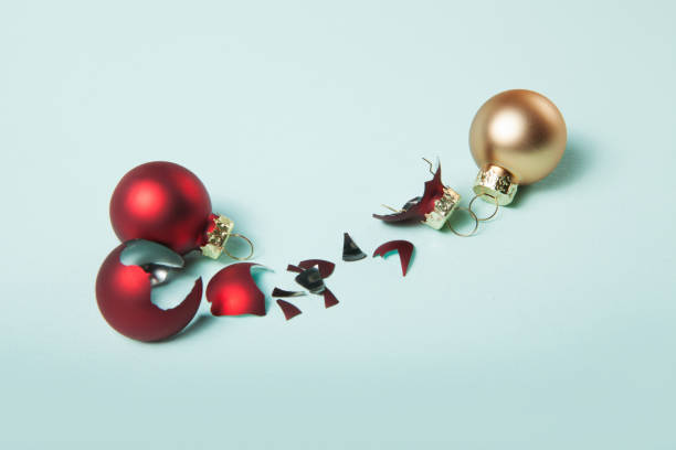 istock Broken red christmas ball and safe two christmas ball on light blue background 1343905026
