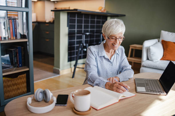 istock Senior woman working on laptop at home 1343907876