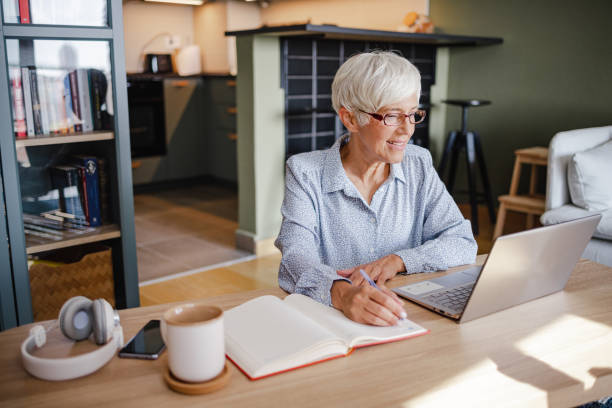 istock Senior woman working on laptop at home 1343908439