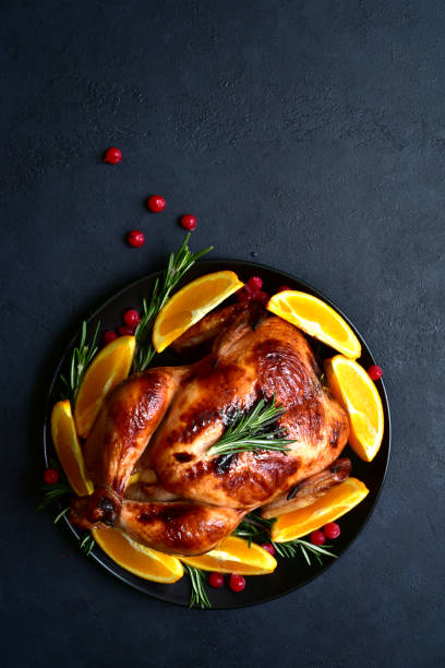 istock Roasted christmas chicken with oranges ,rosemary and cranberries 1343910714